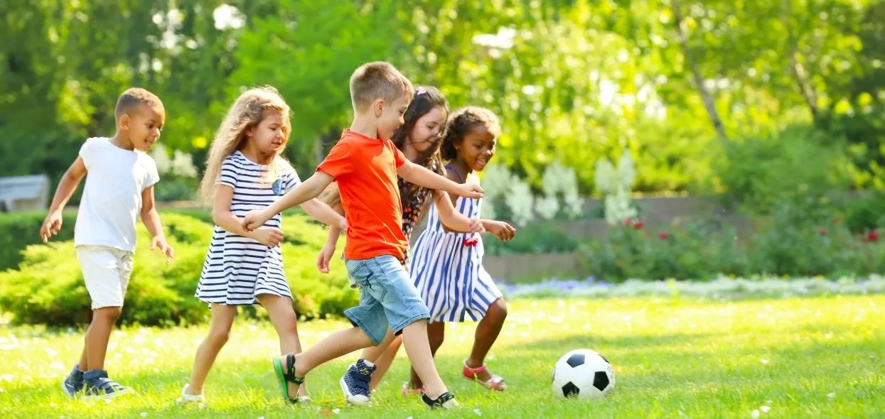 children playing football in dubai community